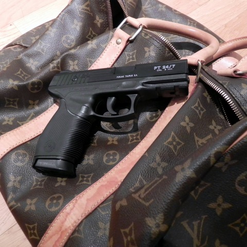 Louis Vuitton bag with gun